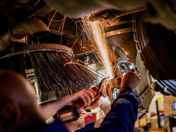Technicus slijpt metaal tijdens onderhoudswerk